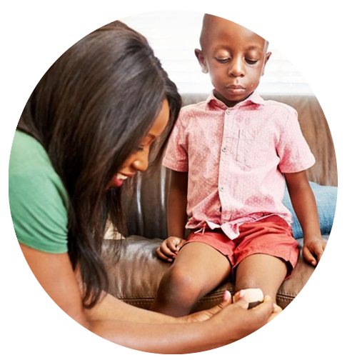 A woman treating a child's scrape.